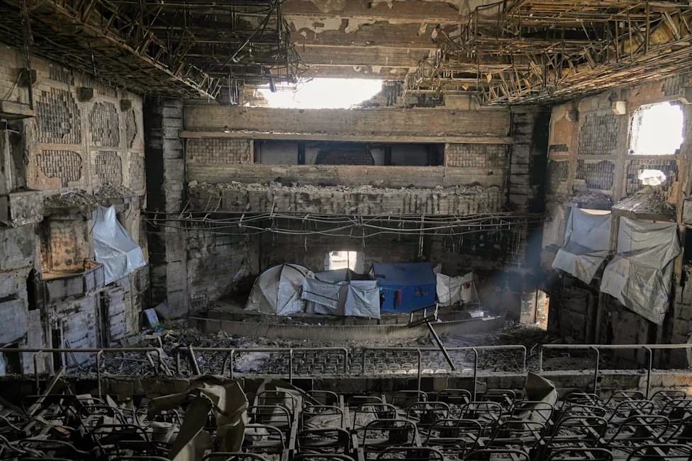 The burned-out main auditorium of the Islamic University of Gaza after the bombing, now a shelter for the displaced